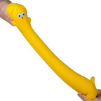 Yellow squishy toy with a face held by a person on a white background