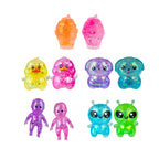 Set of colorful, glittery toy figures on a white background