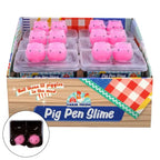 Box of Pig Pen Slime with pink pig-shaped toys and a small inset showing the slime.