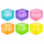 Set of six colorful glittery ice cube toys on a white background
