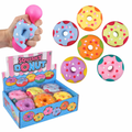 Colorful donut-shaped squishy toy with removable frosting and heart sprinkles on a white background