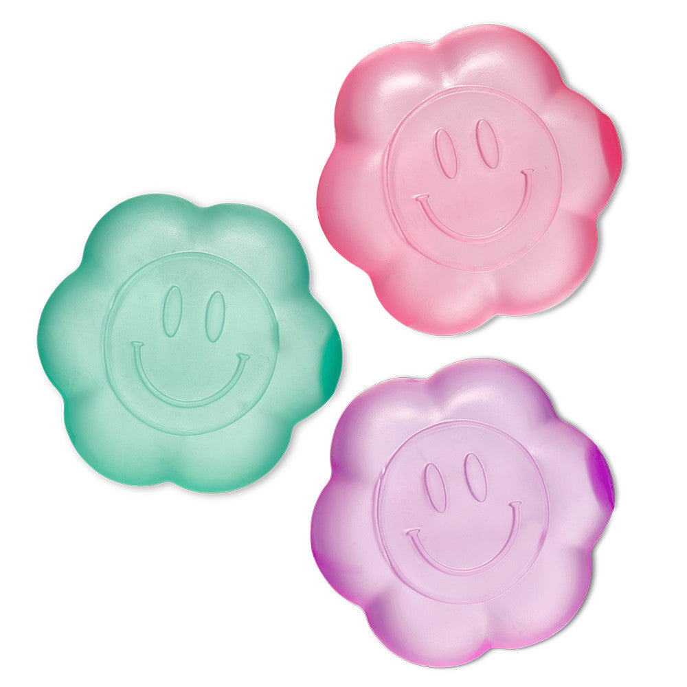 Three colorful smiley face squishy toys on a white background