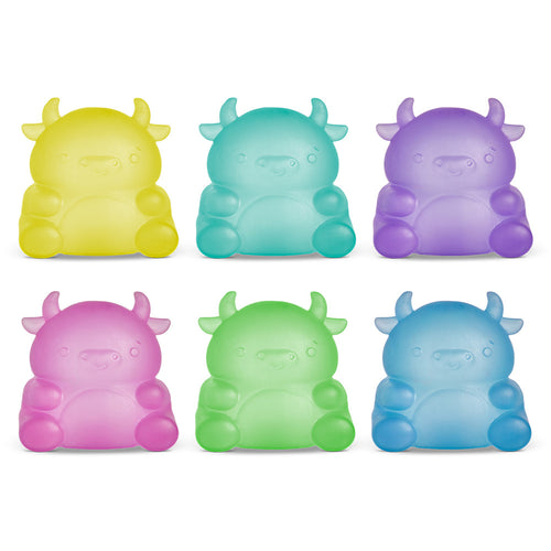Set of six colorful cow-shaped squishies on a white background
