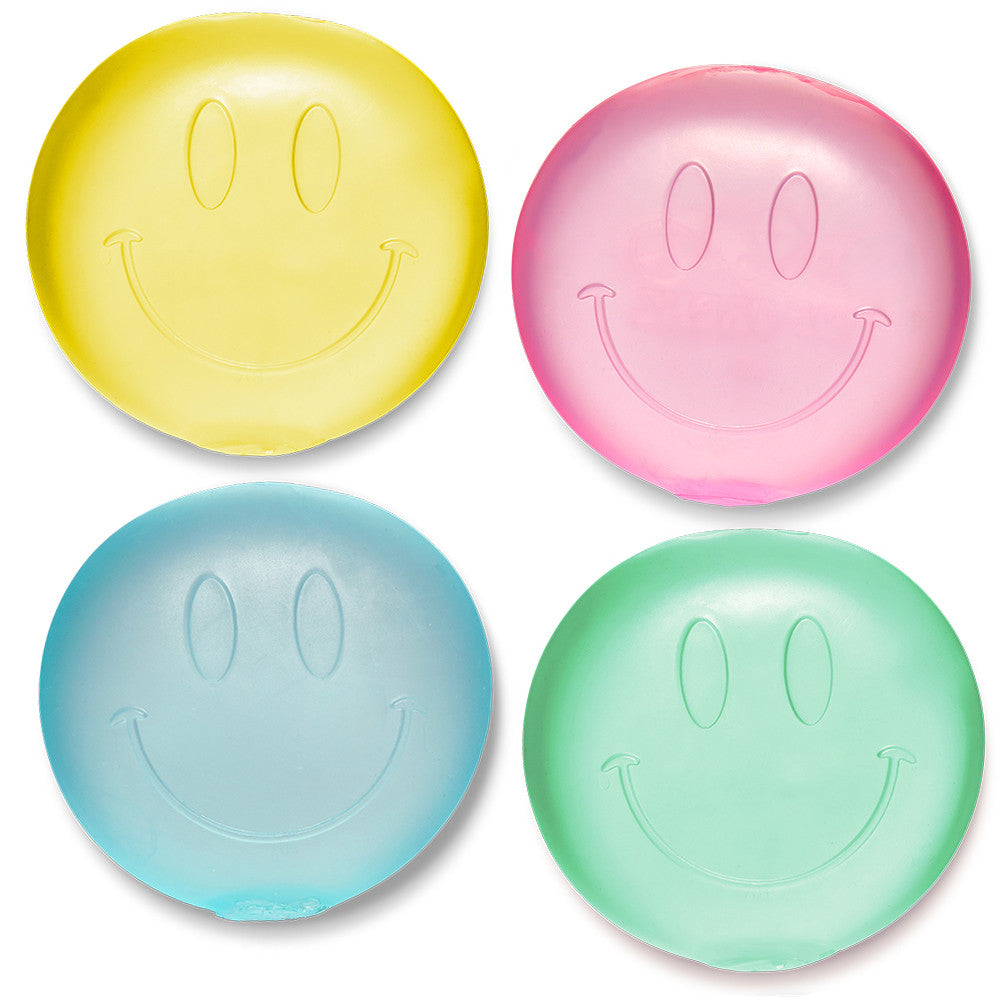 Four smiley face-shaped squishies in yellow, pink, blue, and green on a white background.