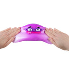 Purple stretchy smusher toy with eyes and a mouth between two hands on a white background