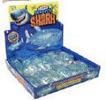 Display box of small blue toys with a shark design on a white background