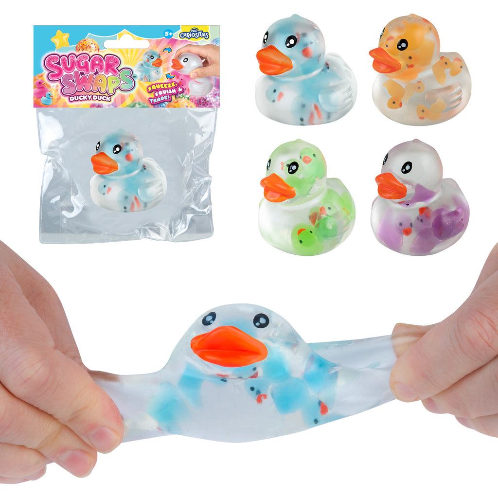 Colorful duck-shaped squishies with packaging on a white background