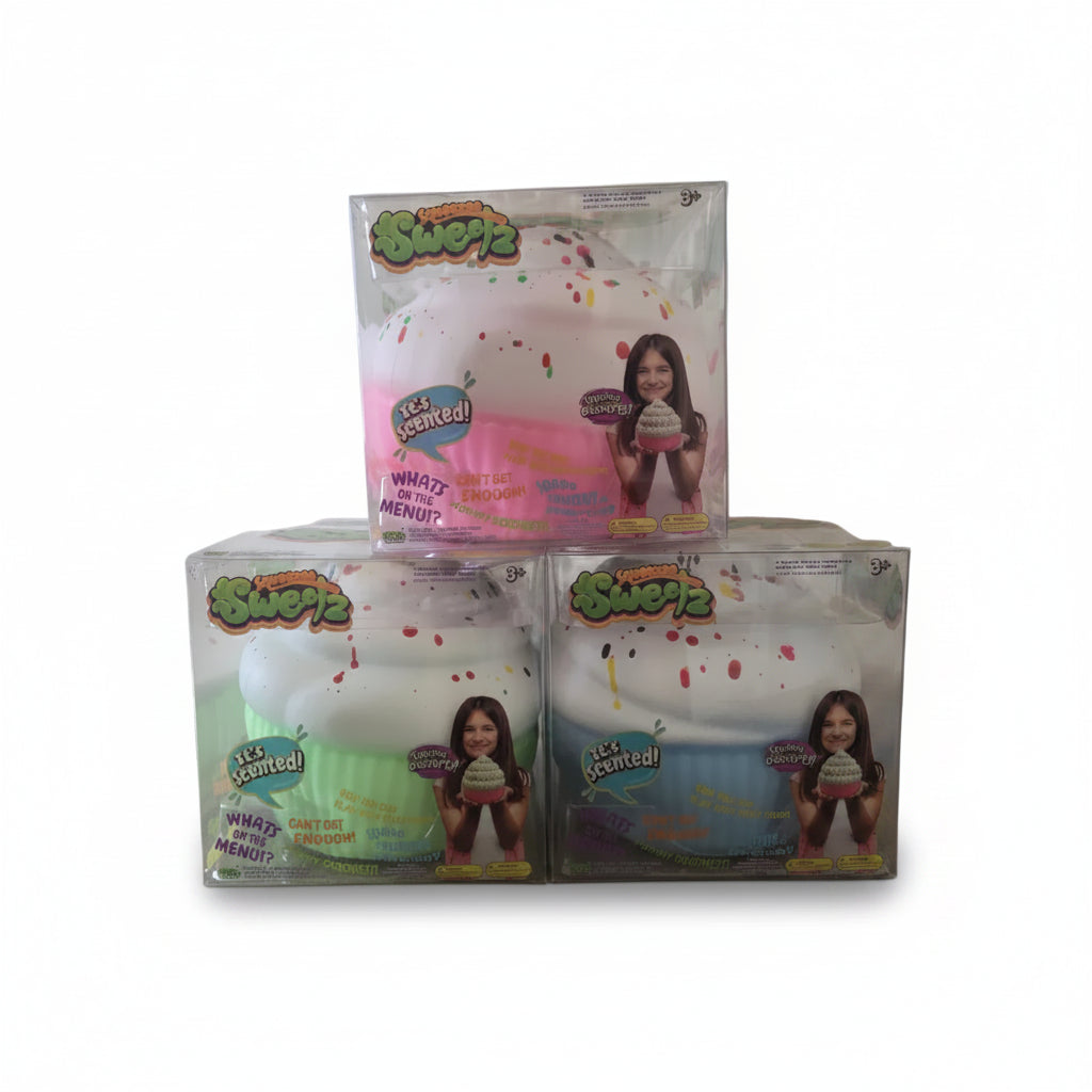 Three packaged Squeezies squishy toys stacked in a pyramid on a white background. The top toy is pink and white, and the bottom two are white with pastel green and blue wrappers.