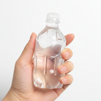 Hand holding a clear water bottle shaped squeeze toy