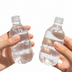 Two clear water bottle squeeze toys held in two hands