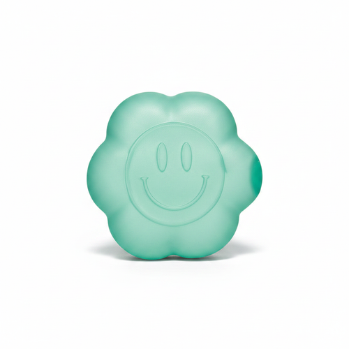 Teal daisy squishy toy with smiley face on white background