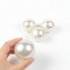 Four pearl white handmade stress balls in different sizes