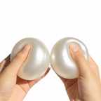 Pearl white handmade stress ball being squeezed