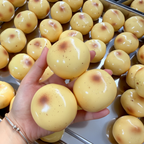 Hand holding two stacked potato squishy balls
